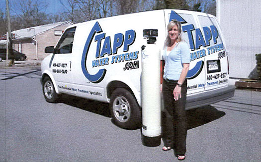 woman standing next to Tapp Water van