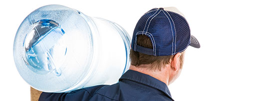 man carrying water jug on shoulder